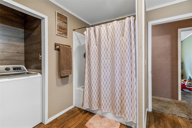 bathroom with shower / bath combination with curtain, washer / dryer, hardwood / wood-style flooring, and crown molding