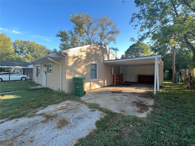 exterior space with a lawn and a carport