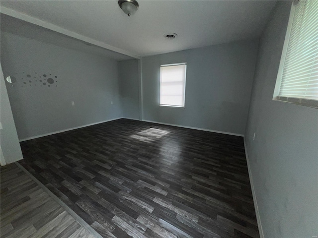 spare room featuring dark hardwood / wood-style floors