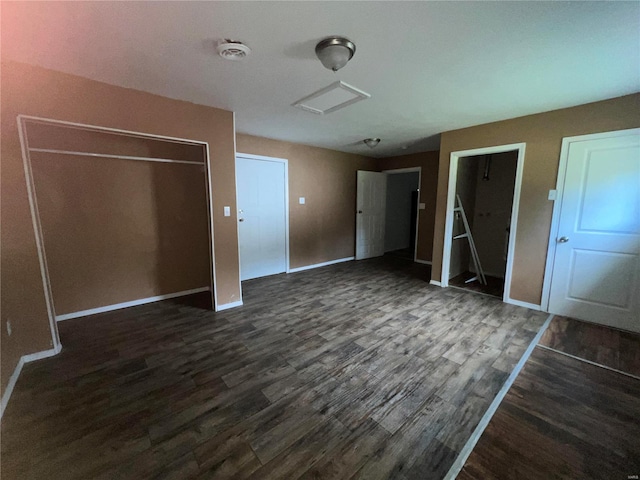 unfurnished bedroom with dark wood-type flooring