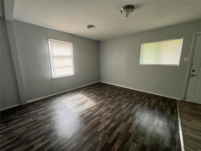 unfurnished room featuring dark hardwood / wood-style floors