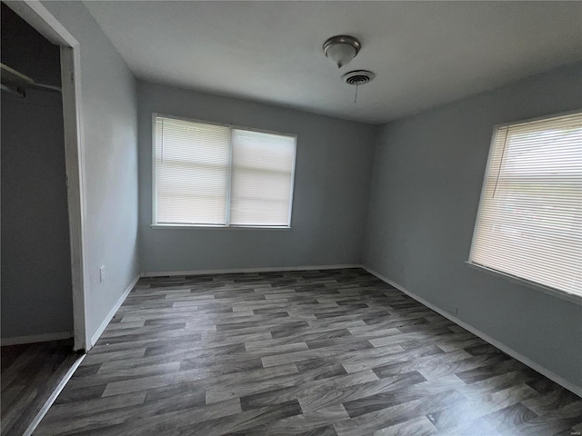 interior space featuring a closet and dark hardwood / wood-style floors