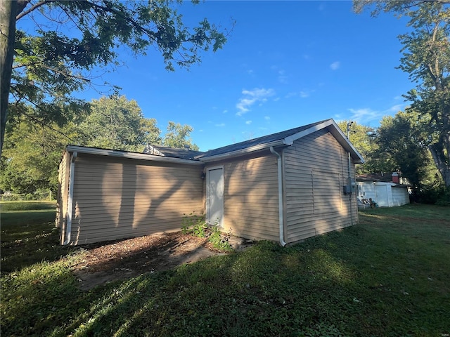 view of home's exterior featuring a yard and a shed