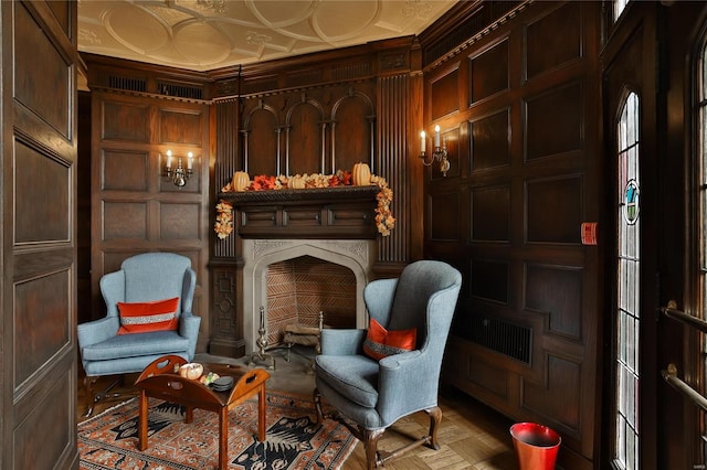 sitting room featuring light parquet flooring, crown molding, and wood walls