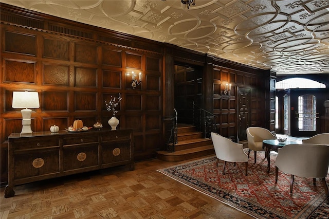 living area featuring wood walls and parquet flooring