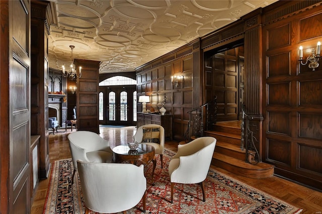 sitting room featuring french doors, parquet floors, and wooden walls