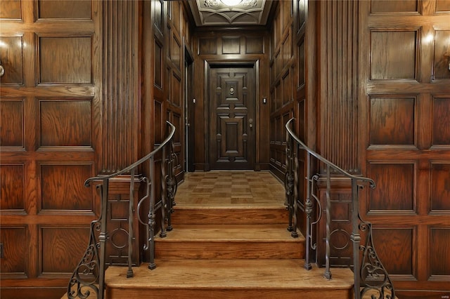 interior space with hardwood / wood-style floors and wood walls