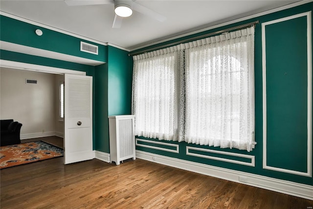 spare room featuring hardwood / wood-style floors and ceiling fan