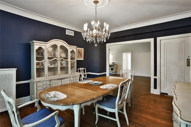 dining space with a notable chandelier, crown molding, and dark wood-type flooring