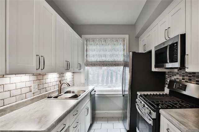 kitchen featuring white cabinets, light tile patterned floors, and appliances with stainless steel finishes