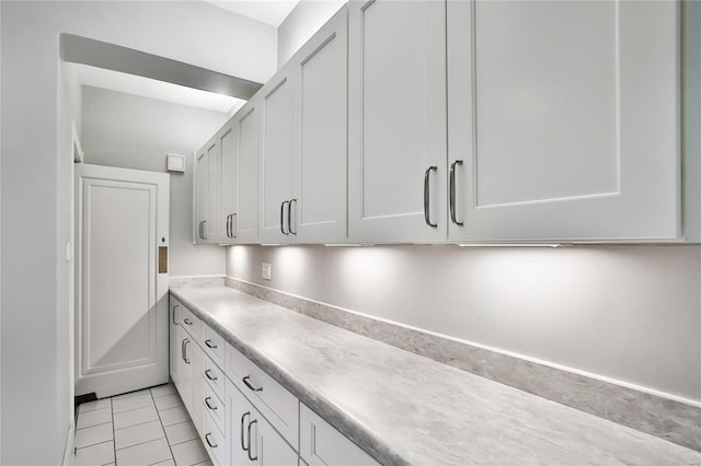 kitchen with white cabinets and light tile patterned floors