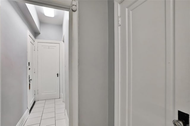 hall featuring light tile patterned flooring