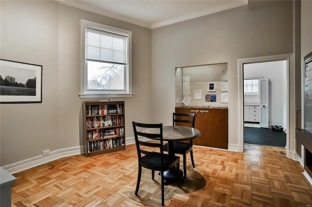 dining room featuring light parquet flooring, plenty of natural light, and crown molding