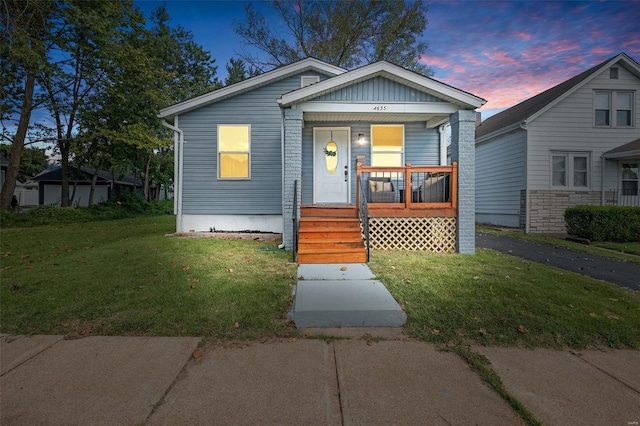 bungalow-style house with a lawn