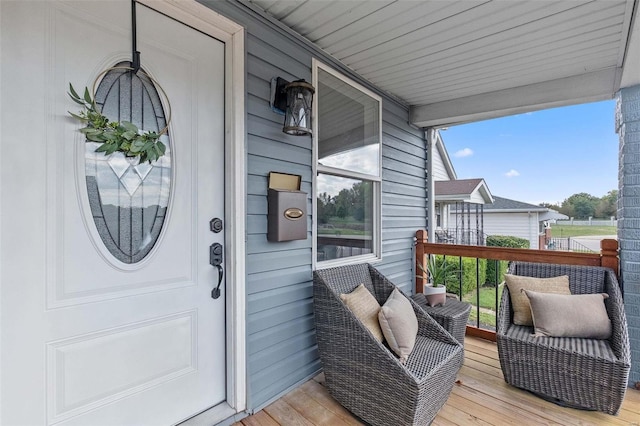 wooden terrace featuring covered porch