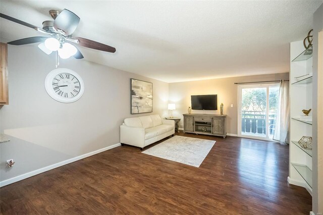 unfurnished living room with ceiling fan, dark hardwood / wood-style flooring, and a textured ceiling