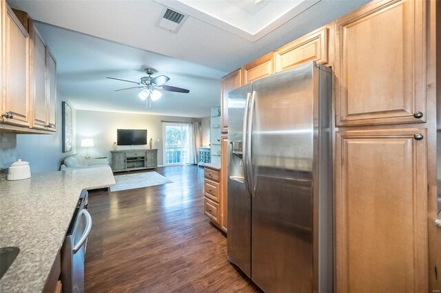 kitchen with appliances with stainless steel finishes, light brown cabinets, dark hardwood / wood-style floors, and ceiling fan