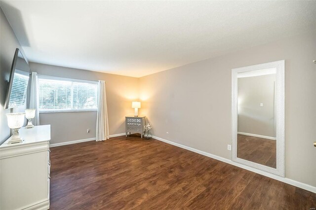 unfurnished room featuring dark hardwood / wood-style floors