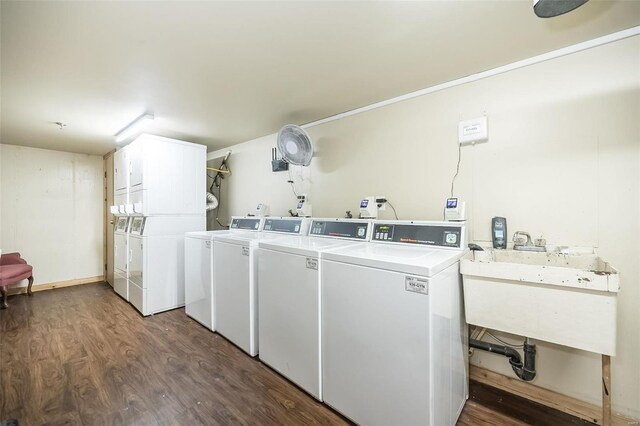 clothes washing area featuring independent washer and dryer, dark wood-type flooring, and stacked washer and clothes dryer