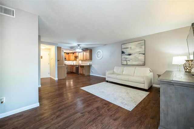 unfurnished living room with dark hardwood / wood-style floors and ceiling fan