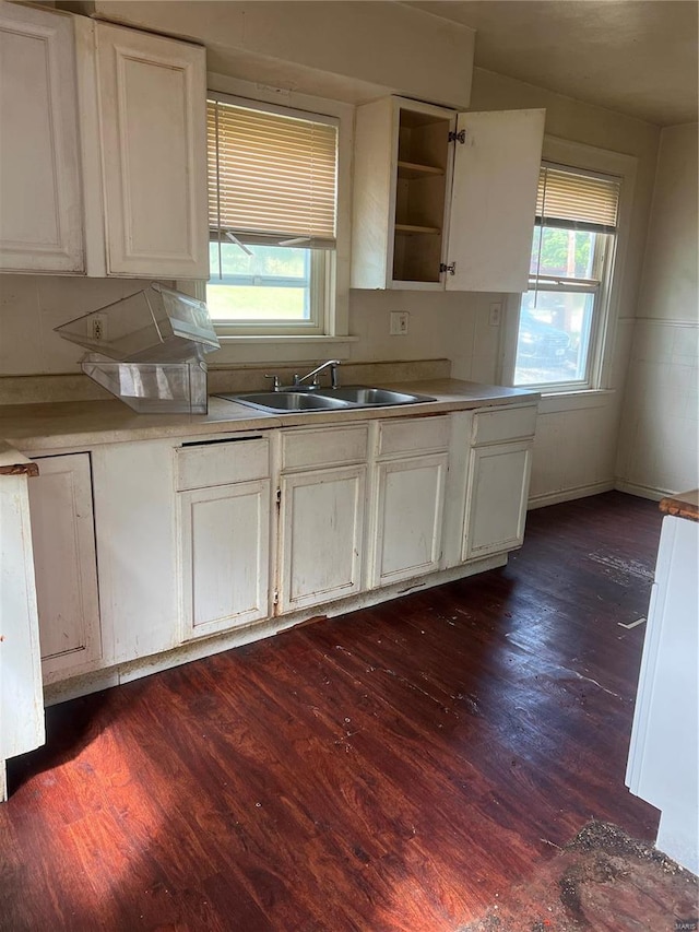 kitchen with sink, dark wood-type flooring, and white cabinetry