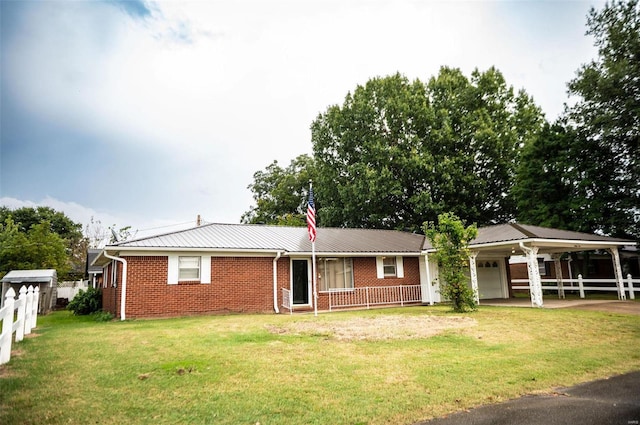 rear view of house with a yard and covered porch