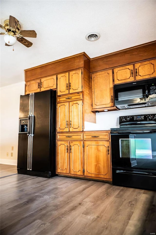 kitchen featuring light wood-type flooring, black appliances, and ceiling fan