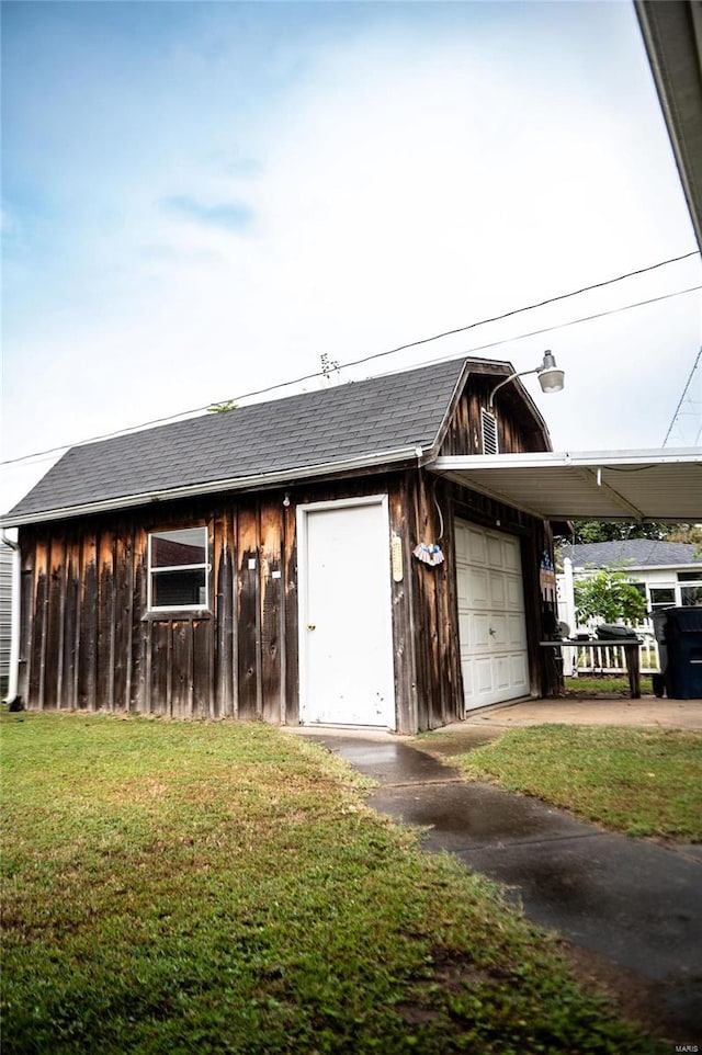 view of outbuilding with a yard and a garage