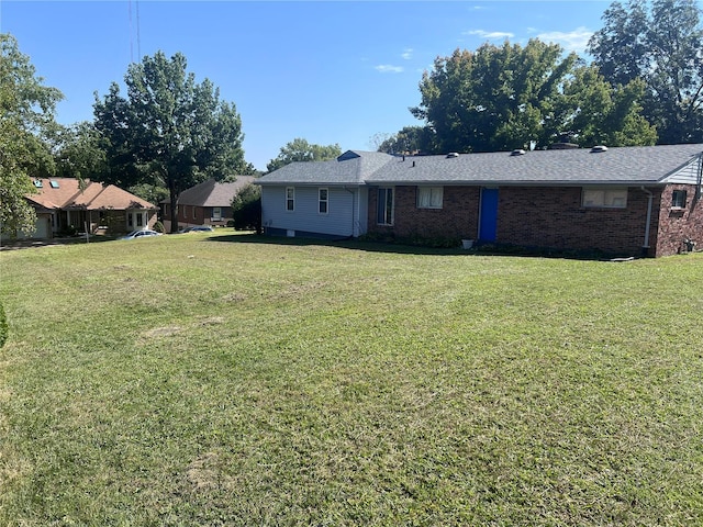 back of house with a lawn