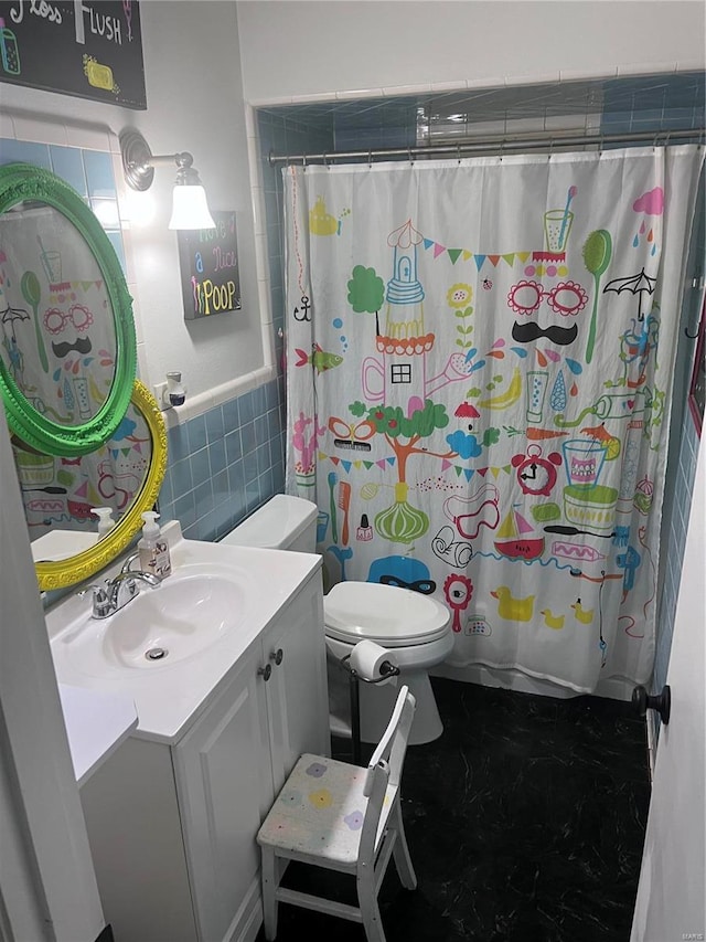 bathroom with tile walls, vanity, toilet, and a shower with shower curtain