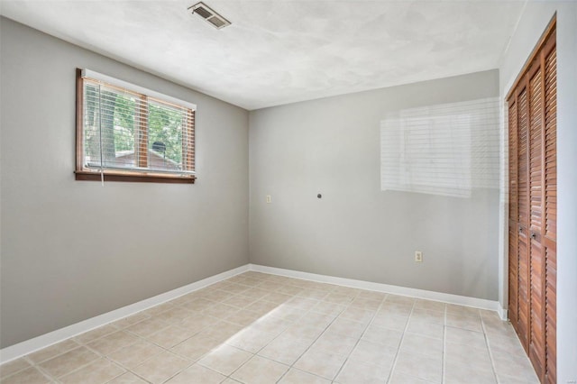 spare room with light tile patterned floors