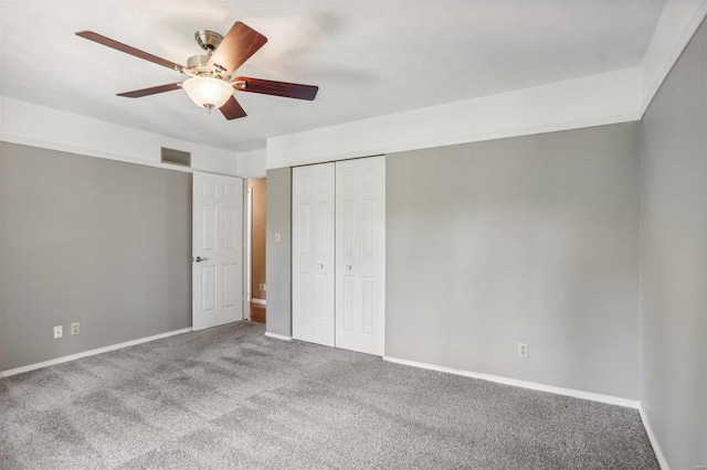 unfurnished bedroom featuring ceiling fan, a closet, and carpet