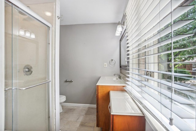 bathroom with an enclosed shower, vanity, and toilet