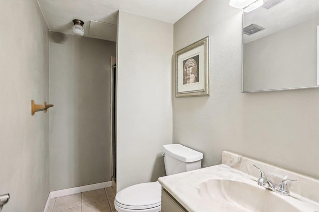 bathroom with tile patterned flooring, a shower with door, vanity, and toilet