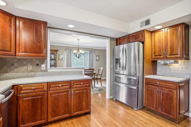 kitchen featuring ornamental molding, decorative light fixtures, stainless steel fridge with ice dispenser, an inviting chandelier, and light wood-type flooring