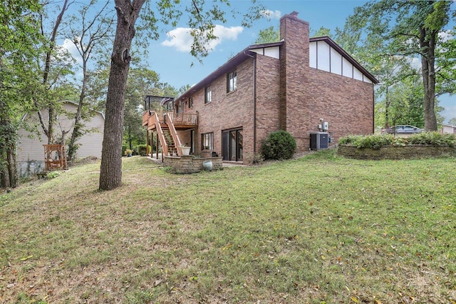 view of side of property with cooling unit, a deck, and a lawn