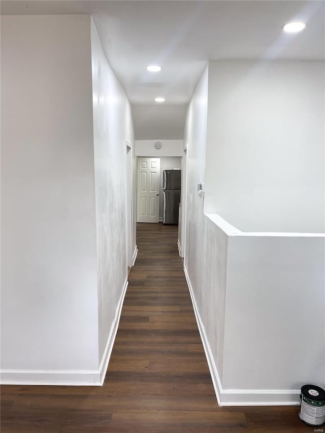 hallway with dark hardwood / wood-style floors