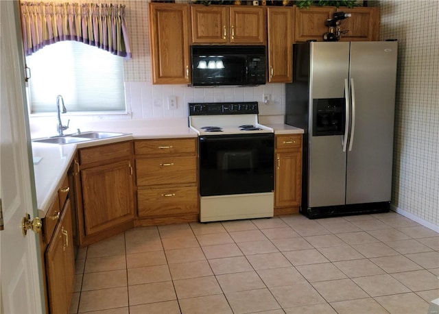 kitchen with white range with electric stovetop, stainless steel fridge with ice dispenser, sink, and light tile patterned floors