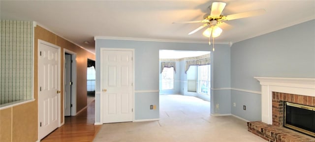 living room featuring light colored carpet, a brick fireplace, ceiling fan, and ornamental molding