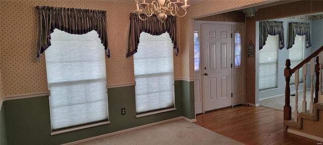 entrance foyer with hardwood / wood-style flooring and a notable chandelier