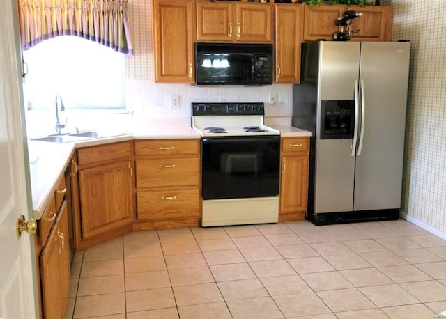 kitchen with range with electric stovetop, sink, decorative backsplash, light tile patterned floors, and stainless steel fridge with ice dispenser