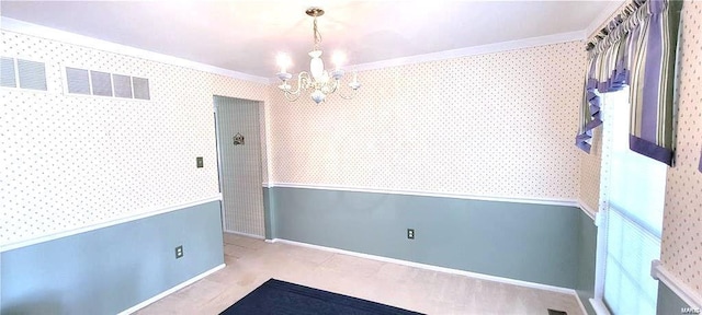 unfurnished room featuring ornamental molding and a notable chandelier