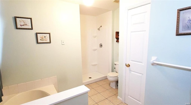 bathroom featuring tile patterned floors, toilet, and a shower