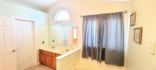 bathroom featuring a tub to relax in, vanity, tile patterned flooring, and vaulted ceiling