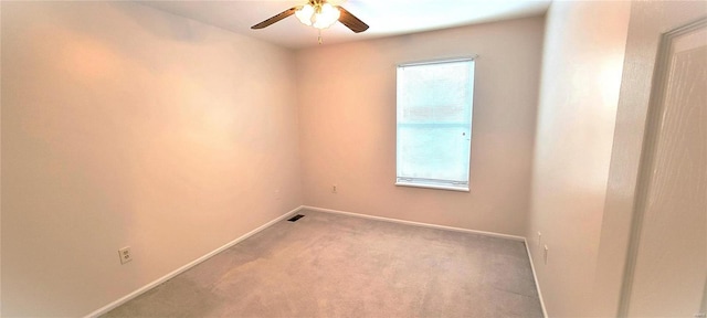 spare room with carpet floors and ceiling fan