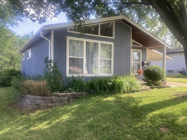 view of side of home with a lawn