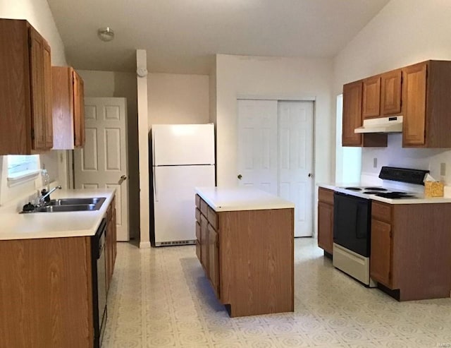 kitchen featuring white appliances, a center island, vaulted ceiling, and sink