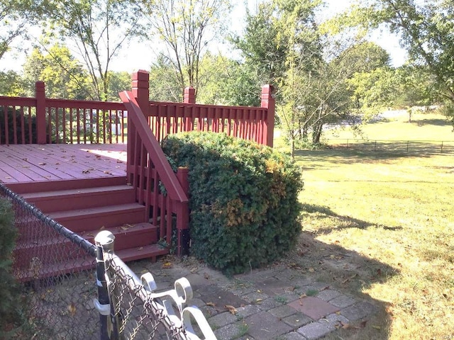 wooden terrace featuring a lawn