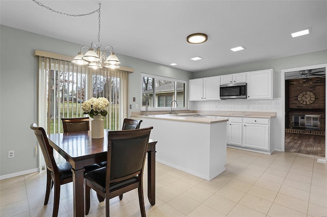 dining space featuring a chandelier, light wood-type flooring, and sink