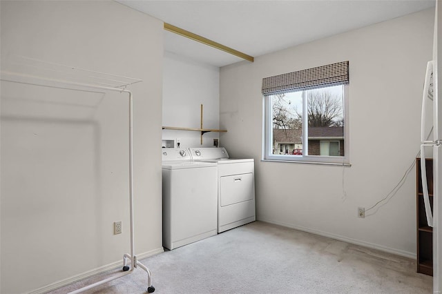 laundry area featuring washer and dryer and light colored carpet